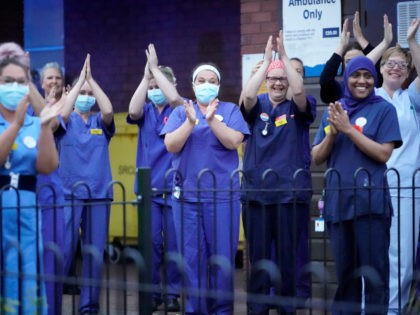 WALSALL, ENGLAND - APRIL 30: NHS staff applaud themselves and their colleagues at the entrance of Walsall Manor Hospital on April 30, 2020 in Walsall, England. Following the success of the "Clap for Our Carers" campaign, members of the public are being encouraged to applaud NHS staff and other key …
