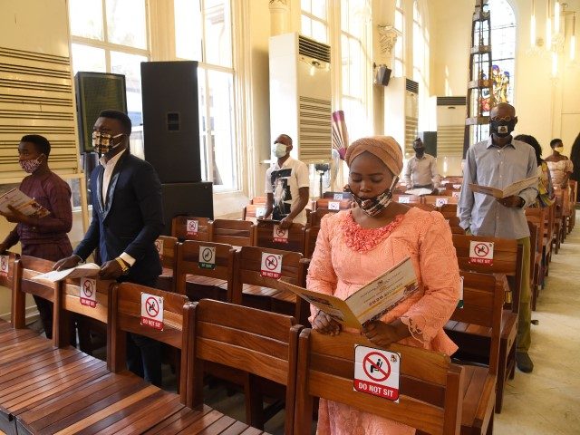Worshippers wearing face masks sing as they attend a mass at the Christ Church Cathedral in Lagos, following the reopening of churches and lifting of restrictions on religious gatherings by the government as a precaution to check the spread of COVID-19, on August 9, 2020. Nigerian government has lifted the …
