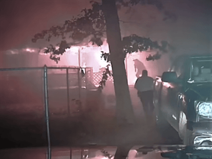 Polk County Sheriff's Office Corporal Roper Ellison and Deputy Darin Brooks rush onto a burning porch to save a wheelchair-bound man from certain death. (Video Screenshot/Polk County Sheriff's Office)