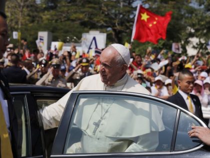 Pope Francis leaves Saint Peter's Parish, a Catholic community outside Bangkok, as a Chinese follower waves his country's flag, in Thailand, Friday, Nov. 22, 2019. Pope Francis tended to the needs of Thailand's tiny Catholic hierarchy Thursday, urging priests and nuns to find ways to communicate the faith with "a …