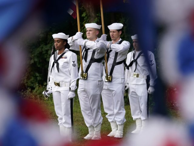 U.S. Navy sailors from the USS Constitution display flags as they form a color guard durin