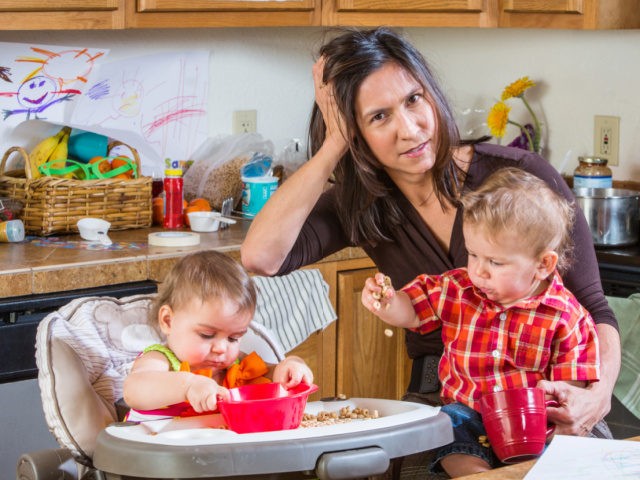 Stressed out mother with two children (Stock photo via Getty)