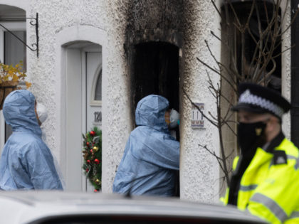 SUTTON, ENGLAND - DECEMBER 17: Forensic officers at the scene of a house fire that claimed the lives of four children on December 17, 2021 in Sutton, England. Emergency Services attended a house fire in Sutton, South London yesterday evening. Four children were recovered from the scene but were pronounced …