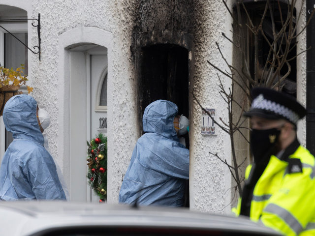 SUTTON, ENGLAND - DECEMBER 17: Forensic officers at the scene of a house fire that claimed