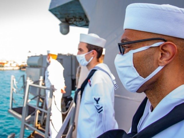 Sailors man the rails as the guided-missile destroyer USS Winston S. Churchill (DDG 81) ar