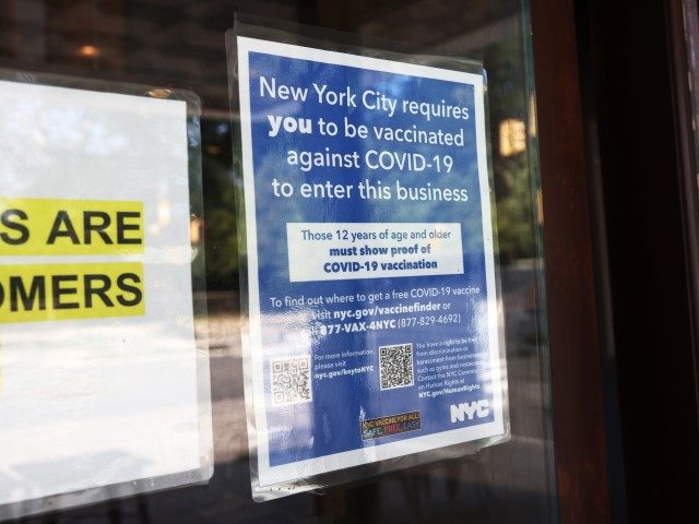 NEW YORK, NEW YORK - SEPTEMBER 08: A coronavirus (COVID-19) vaccination sign is seen posted at the entrance of Nighthawk Cinema on September 08, 2021 in the Park Slope neighborhood of Brooklyn in New York City. On August 16, NYC became the first U.S. city to start a transition period …