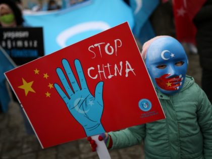 A protester from the Uyghur community living in Turkey, holds an anti-China placard during a protest in Istanbul, Thursday, March 25, against against the visit of China's FM Wang Yi to Turkey. Hundreds of Uyghurs staged protests in Istanbul and the capital Ankara, denouncing Wang Yi's visit to Turkey and …