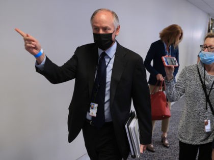 WASHINGTON, DC - SEPTEMBER 29: White House Counselor to the President Steve Ricchetti (L) is pursued by reporters after leaving a meeting with Sen. Kyrsten Sinema (D-AZ) in the Hart Senate Office Building on Capitol Hill September 29, 2021 in Washington, DC. With a federal government shutdown looming, Congressional Democrats …