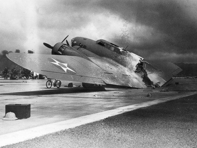 7th December, 1941: A damaged B-17C Flying Fortress bomber sits on the tarmac near Hangar Number 5 at Hickam Field, after the Japanese attack on Pearl Harbor, Hawaii.