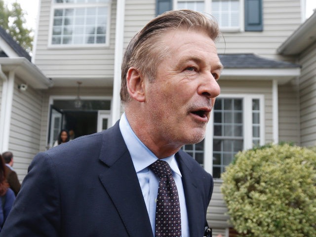 Actor Alec Baldwin, right ,walks with Amanda Pohl, candidate for Virginia Senate District 11, as they leave a home in her neighborhood in Midlothian, Va., Tuesday, Oct. 22, 2019. Baldwin campaigned for several candidates around the state. (AP Photo/Steve Helber)