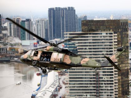 MELBOURNE, AUSTRALIA - JULY 20: An Army Sikorsky S-70A-9 Black Hawk helicopter flies above the city skyline on July 20, 2007 in Melbourne, Australia. The No 171 Squadron will be conducting eight days of helicopter training operations at various military establishments and around the Melbourne CBD during the period. (Photo …