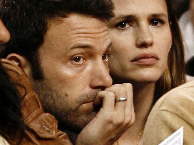 Actor Ben Affleck and his wife, actress Jennifer Garner, watch during the fourth quarter o