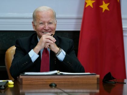 President Joe Biden meets virtually with Chinese President Xi Jinping from the Roosevelt Room of the White House in Washington, Monday, Nov. 15, 2021. (AP Photo/Susan Walsh)