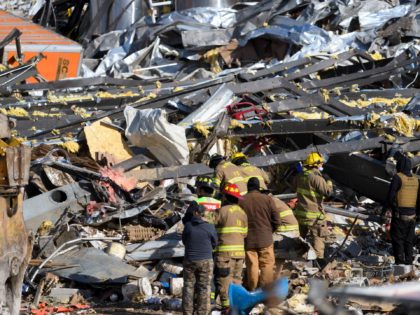 Emergency workers search through what is left of the Mayfield Consumer Products Candle Factory after it was destroyed by a tornado in Mayfield, Kentucky, on December 11, 2021. - Tornadoes ripped through five US states overnight, leaving more than 70 people dead Saturday in Kentucky and causing multiple fatalities at …