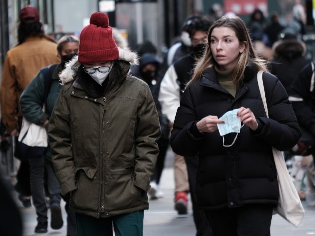 NEW YORK, NEW YORK - NOVEMBER 29: People wear face masks in Manhattan on November 29, 2021