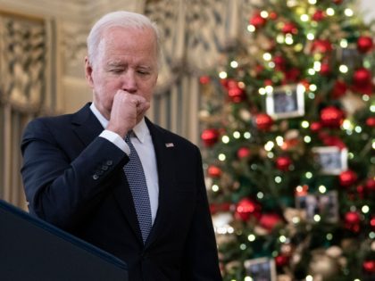 US President Joe Biden coughs as he talks to reporters about the November Jobs Report from