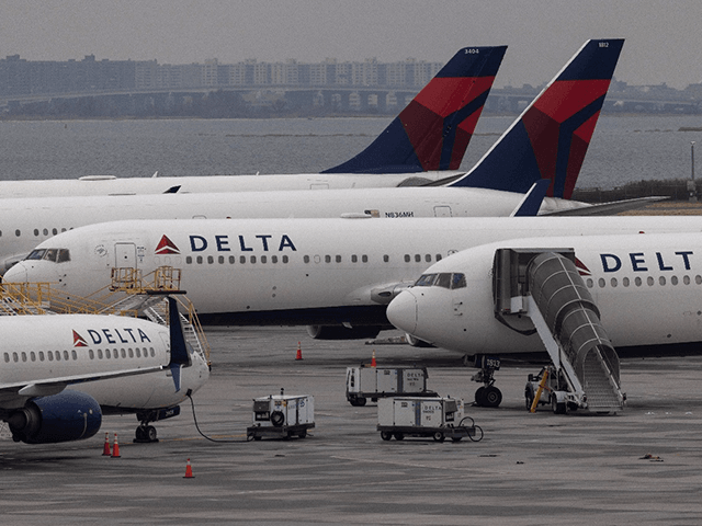 Delta Airlines passenger planes sit on the tarmac of John F. Kennedy International Airpot