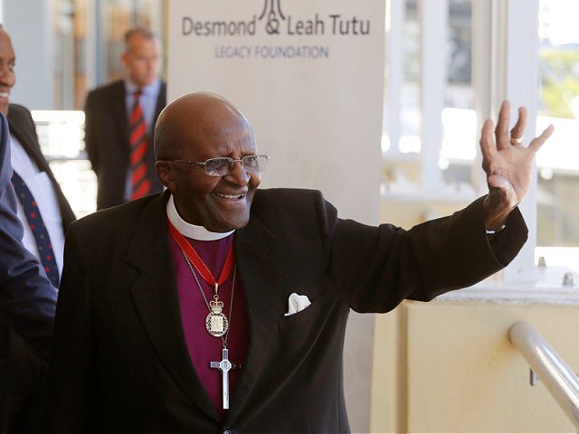 FILE - Britain's Prince Harry, left, looks on as South African Archbishop Emeritus Desmond