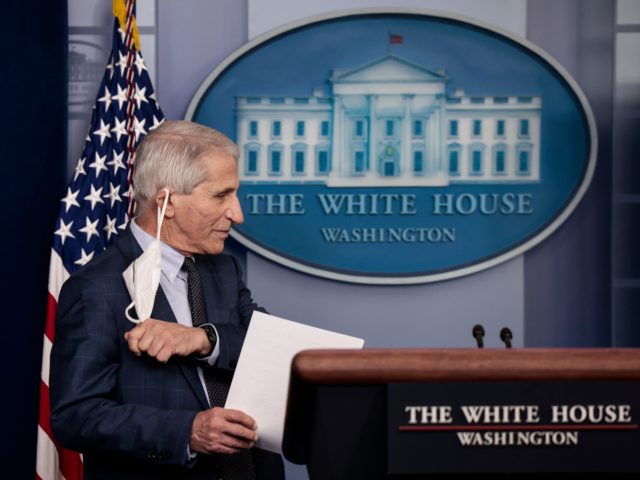 WASHINGTON, DC - DECEMBER 01: Dr. Anthony Fauci, Director of the National Institute of Allergy and Infectious Diseases and the Chief Medical Advisor to the President, takes his face mask off before giving an update on the Omicron COVID-19 variant during the daily press briefing at the White House on …