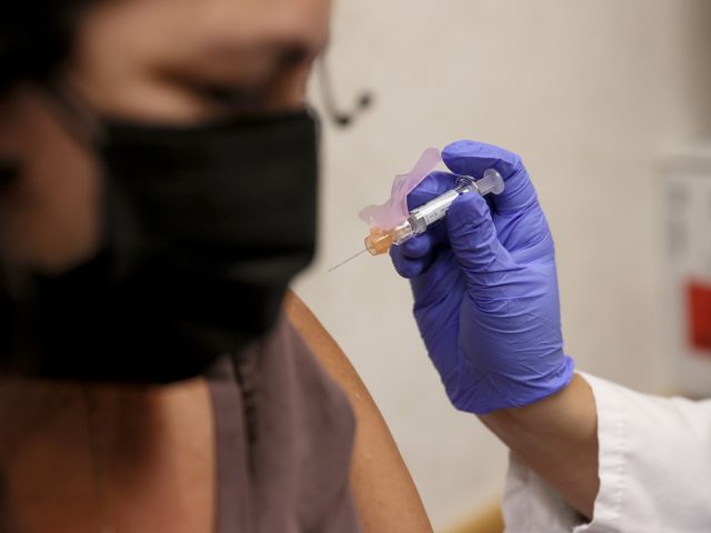 MIAMI, FLORIDA - SEPTEMBER 10: Susana Sanchez, a Nurse Practitioner, administers a flu vac
