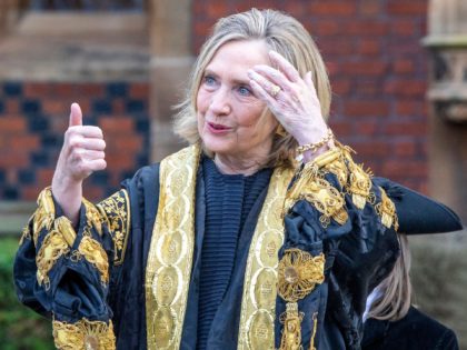 Former United States Secretary of State, Hilary Clinton gestures after being officially installed as Queen's University's 11th chancellor and the first female chancellor, at Queen's University in Belfast on September 24, 2021. - Hilary Clinton was appointed in January 2020, but has not been able to visit the university in …