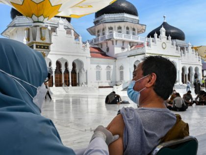 A man receives a dose of the Moderna against Covid-19 coronavirus vaccine during a vaccination drive at the Baiturrahman grand mosque in Banda Aceh on September 7, 2021. (Photo by CHAIDEER MAHYUDDIN / AFP) (Photo by CHAIDEER MAHYUDDIN/AFP via Getty Images)