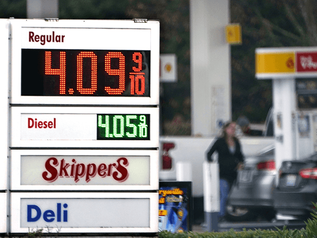 A driver fills a tank at a gas station Friday, Dec. 10, 2021, in Marysville, Wash. Consume