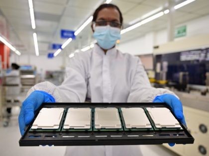 Intel manufacturing technicians in Kulim, Malaysia, display 3rd Gen Intel Xeon Scalable processors during their production cycle. Intel introduces the 3rd Gen Intel Xeon Scalable processors (code-named "Ice Lake") and the full platform that they join on Tuesday, April 6, 2021. (Credit: Jason Cheah/Intel Corporation via AP)