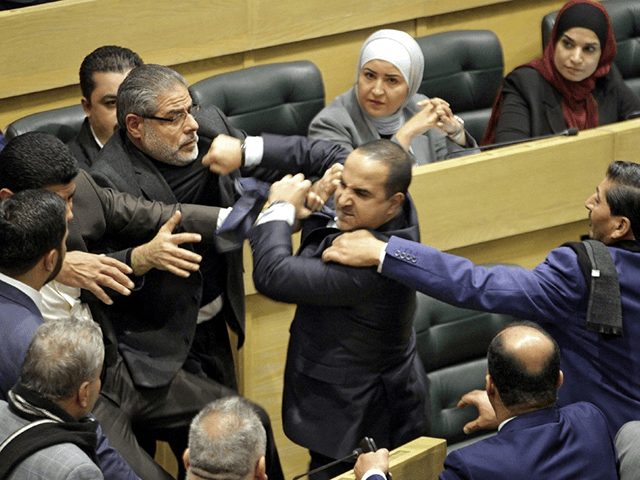 Jordanian parliament members are separated during an altercation in the parliament in the