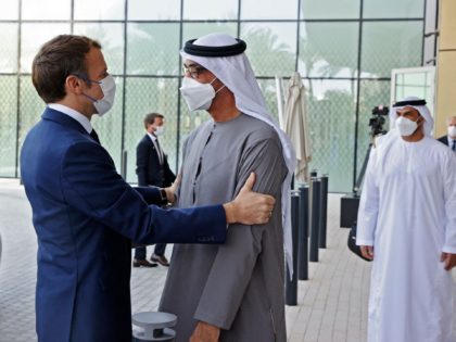 French President Emmanuel Macron (L) is greeted by Abu Dhabi's Crown Prince Mohammed bin Zayed al-Nahyan at the Dubai Expo on the first day of his Gulf tour on December 3, 2021. (Photo by Thomas SAMSON / AFP) (Photo by THOMAS SAMSON/AFP via Getty Images)
