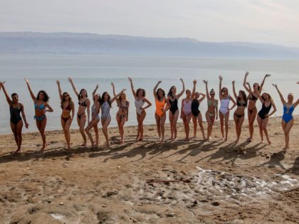 Contestants of the Miss Universe pageant pose for a picture during a visit to the Dead Sea, south of the West Bank city of Jericho, on December 4, 2021 ahead of the 70th Miss Universe event to be held in Israel's Red Sea resort of Eilat on December 12. (Photo …