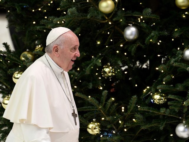 Pope Francis walks by a Christmas tree during the general audience at the Paul VI Hall at