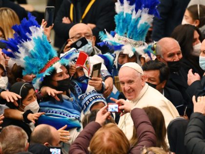 Pope Francis (C-R) greets members of a Peruvian delegation who donated the Christmas nativity scene during an audience to the Delegations of the Christmas Tree and Nativity Scene of St Peter's Square on December 10, 2021 at Paul-VI hall in the Vatican. (Photo by Vincenzo PINTO / AFP) (Photo by …