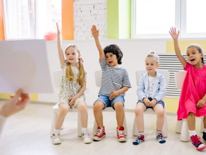 Children Raising Their Hands in a Classroom