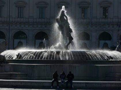 Men are sitting near the Fountain of the Naiads on April 20, 2016 at Piazza della Repubblica in Rome. AFP PHOTO / GABRIEL BOUYS / AFP / GABRIEL BOUYS (Photo credit should read GABRIEL BOUYS/AFP via Getty Images)