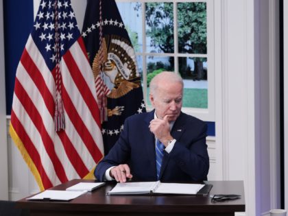 WASHINGTON, DC - DECEMBER 27: U.S. President Joe Biden listens during a video call with the White House Covid-19 Response team and the National Governors Association in the South Court Auditorium at the Eisenhower Executive Office Building on December 27, 2021 in Washington, DC. President Biden spoke to governors about …