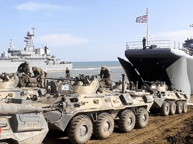 This handout photo taken from a video released on Friday, April 23, 2021 by Russian Defense Ministry Press Service shows, Russian military's armored vehicles roll into landing vessels after drills in Crimea. Russian Defense Minister Sergei Shoigu on Thursday ordered troops back to their permanent bases after a massive military …