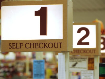 In this Sept. 23, 2011 photo, a row of self checkout lines are available at a Big Y supermarket in Manchester, Conn. According to a three-month AP investigation released in January 2013, five years after the start of the Great Recession, instead of relying on someone else in the workplace …