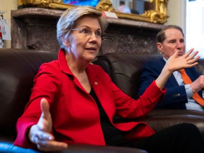 WASHINGTON, DC - OCTOBER 26: (L-R) U.S. Sens. Elizabeth Warren (D-MA) and Ron Wyden (D-OR) speak to reporters about a corporate minimum tax plan at the U.S. Capitol October 26, 2021 in Washington, DC. The senators detailed a plan that would levy a 15% minimum corporate tax on declared incomes …