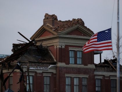 MAYFIELD, KY - DECEMBER 11: A tattered American flag flies at half-mast for Sen. Bob Dole in front of the heavy tornado-damaged courthouse on December 11, 2021 in Mayfield, Kentucky. Multiple tornadoes tore through parts of the lower Midwest late on Friday night leaving a large path of destruction and …