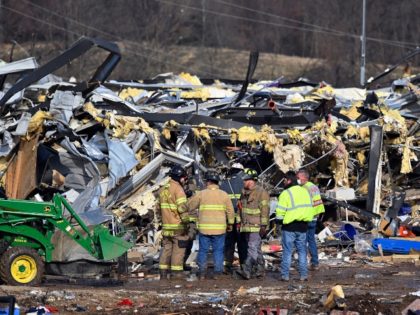 Emergency response workers dig through the rubble of the Mayfield Consumer Products candle factory in Mayfield, Ky., Saturday, Dec. 11, 2021. Tornadoes and severe weather caused catastrophic damage across multiple states late Friday, killing several people overnight. (AP Photo/Timothy D. Easley)