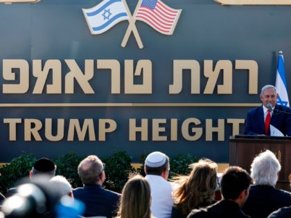 Israeli Prime Minister Benjamin Netanyahu gives a speech before the newly-unveiled sign for the new settlement of "Ramat Trump", or "Trump Heights" in English, named after the incumbent US President during an official ceremony in the Israeli-annexed Golan Heights on June 16, 2019. - Netanyahu unveiled a "Trump Heights" sign …