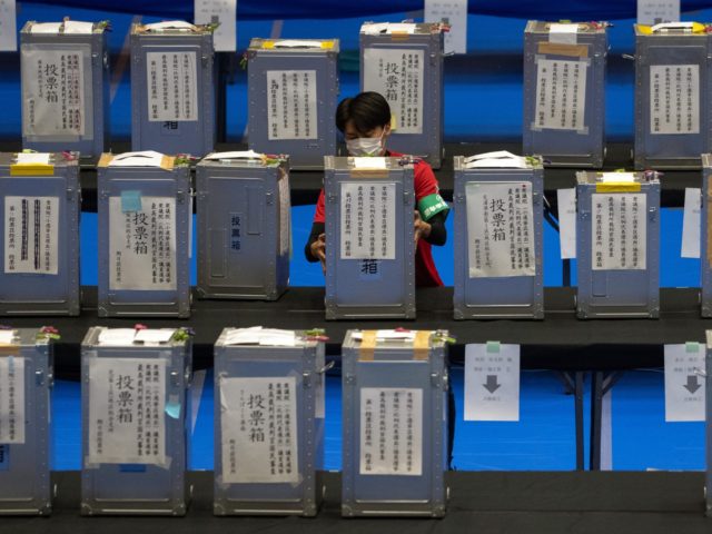 TOKYO, JAPAN - OCTOBER 31: An electoral official carries a ballot box into a counting cent