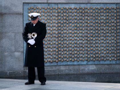 WASHINGTON, DC - DECEMBER 07: A trumpeter with a military honor guard pauses at the World War II Memorial during a wreath-laying ceremony to mark National Pearl Harbor Remembrance Day on December 7, 2020 in Washington, DC. On Dec. 7th, 1941, more than 2,400 Americans lost their lives in the …