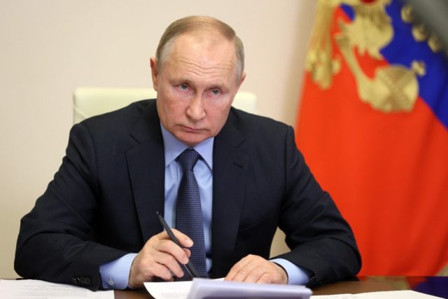 Russian President Vladimir Putin attends a meeting of the presidential rights council via