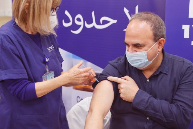 An Israeli man receives a fourth dose of the Pfizer-BioNTech vaccine against Covid-19 at t