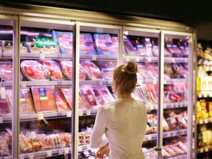 Woman choosing deli products at supermarket.