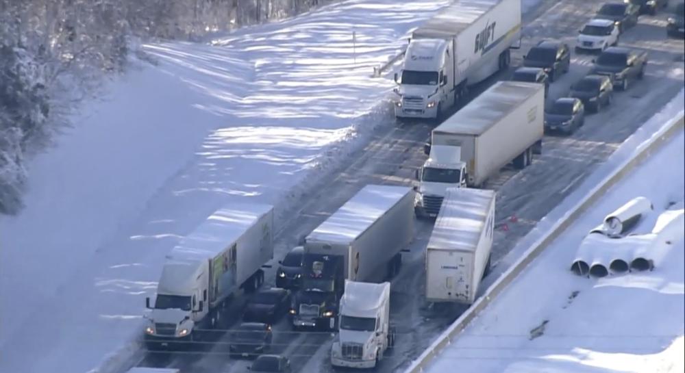 Motorists sit stranded on Interstate 95 in Northern, Va., on Tuesday, Jan. 4, 2022. Hundreds of motorists were stranded all night in snow and freezing temperatures along a 50-mile stretch of Interstate 95 after a crash involving six tractor-trailers in Virginia, where authorities were struggling Tuesday to reach them. (WJLA via AP)