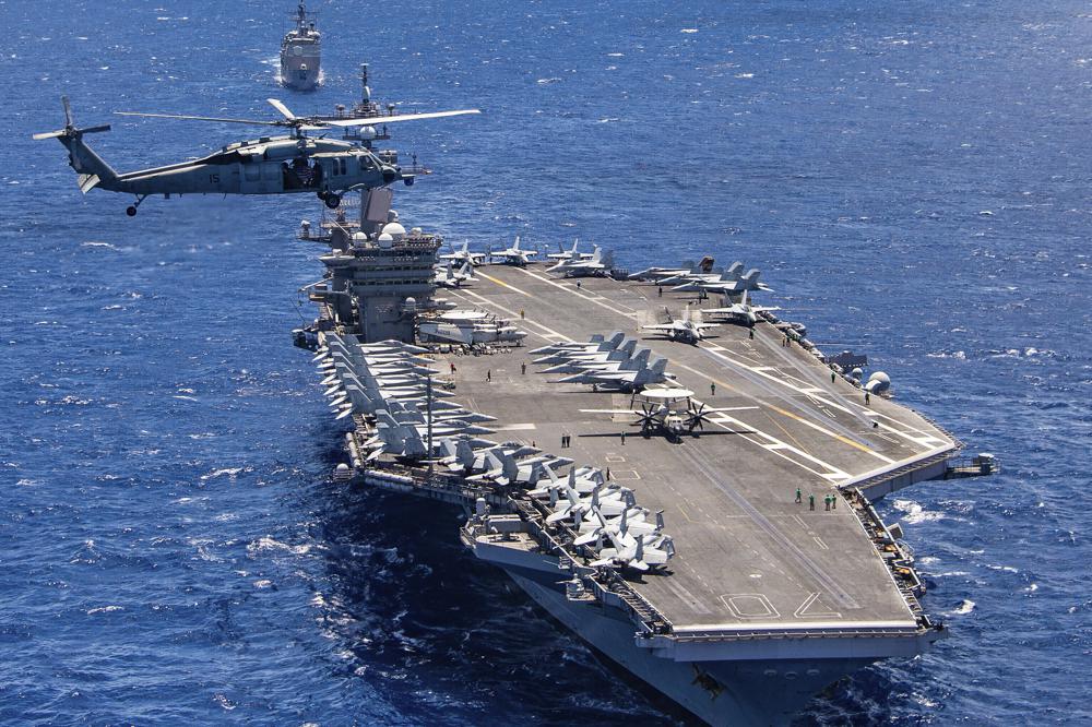 In this photo provided by the U.S. Navy, the aircraft carrier USS Carl Vinson participates in a group sail during the Rim of the Pacific exercise off the coast of Hawaii, July 26, 2018. The U.S. military says a Navy F35C Lightning II combat jet conducting exercises in the South China Sea has crashed while trying to land on the deck of the USS Carl Vinson, injuring seven sailors, Monday, Jan. 24, 2022, the military said. (Petty Officer 1st Class Arthurgwain L. Marquez/U.S. Navy via AP, File)