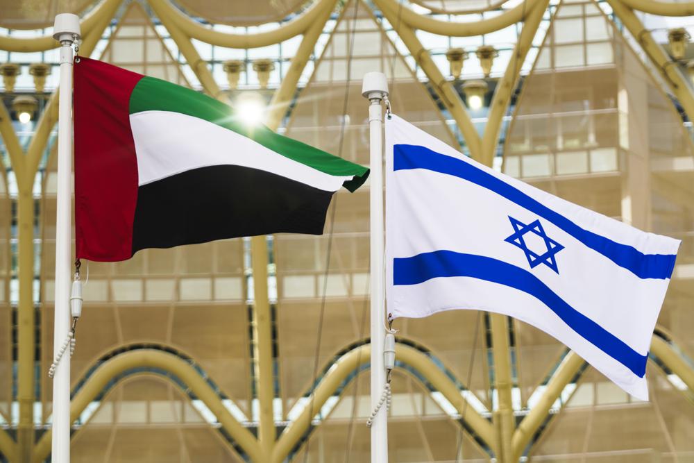 The Emirati and Israeli flags fly overhead as Israeli President Isaac Herzog gives a speech at Expo 2020 in Dubai, United Arab Emirates, Monday, Jan. 31, 2022. The UAE intercepted a ballistic missile fired by Yemen's Houthi rebels early Monday as the Israeli president visited the country, authorities said, the third such attack in recent weeks. (AP Photo/Jon Gambrell)